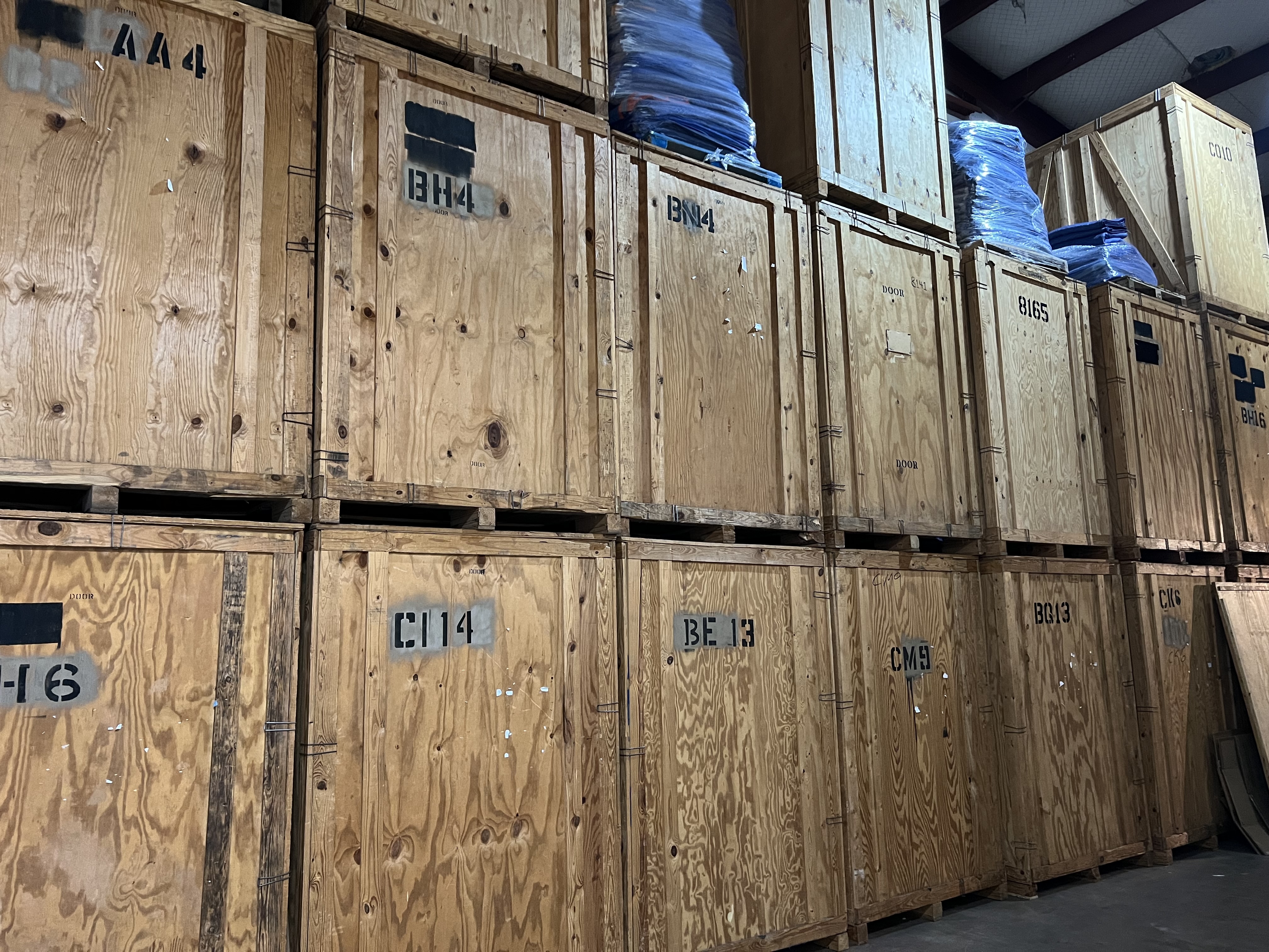 Wooden storage vaults organized in a warehouse